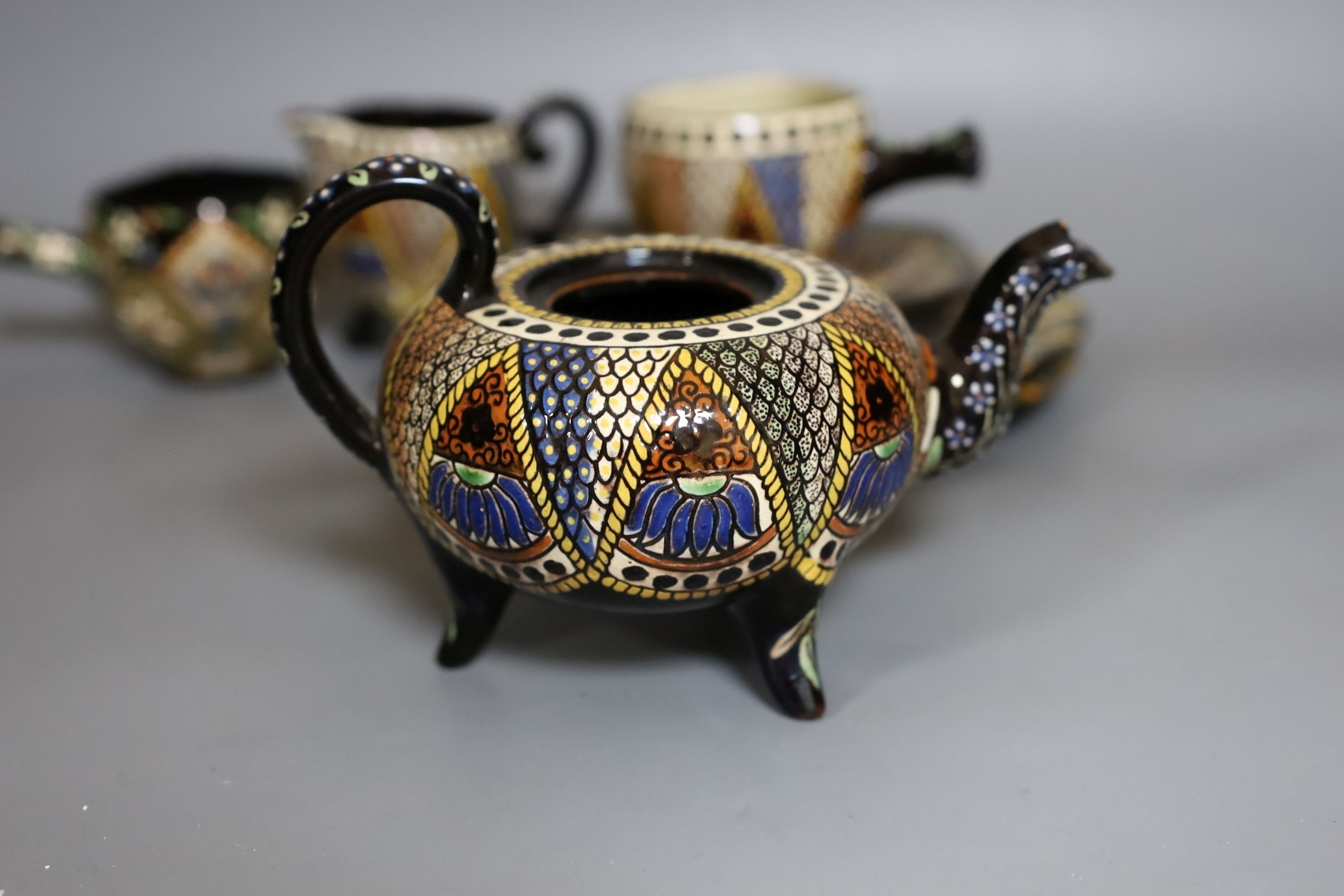 A Swiss Thoune treacle glazed incised pottery tea set, with coloured decoration (8)